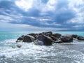 Sea Ã¢â¬â¹Ã¢â¬â¹coast with rocks after a storm, black clouds in the sky. Royalty Free Stock Photo